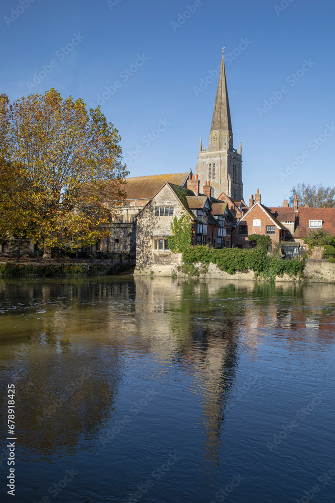 A view across the river at Abingdon on Thames. Across the river is the spire of St Helens church is reflected in the water