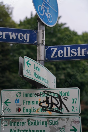 Vertical shot of different street signs © Wirestock