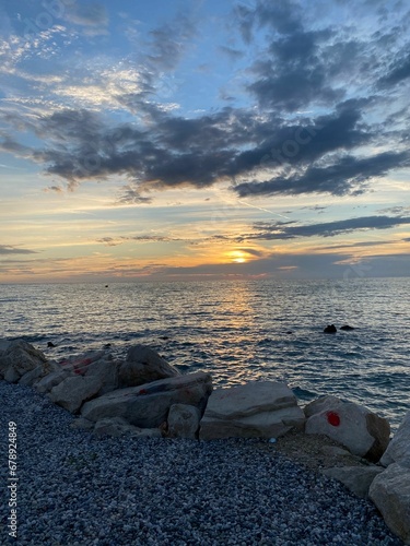 Scenic view of the sunset over the rocks coast during summer