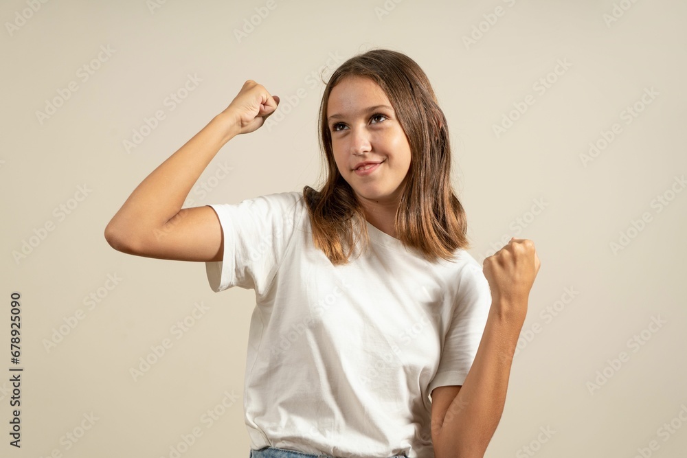 Young teen girl with fist up on the white background Young teen girl with fist up on the white background