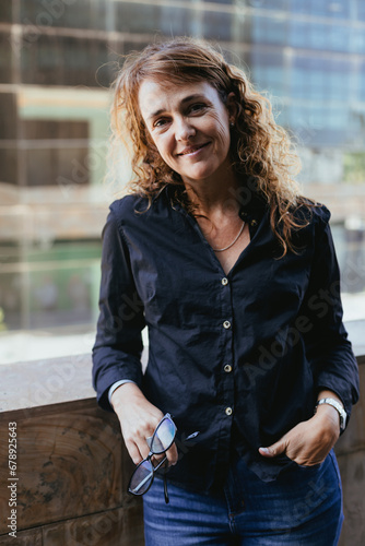 Business Casual Outdoors: Mature Woman 50+ in Black Shirt, Jeans at Office