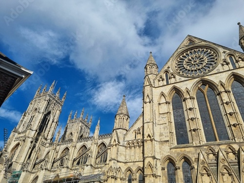Low-angle shot of the York Minster under a cloudy sky photo