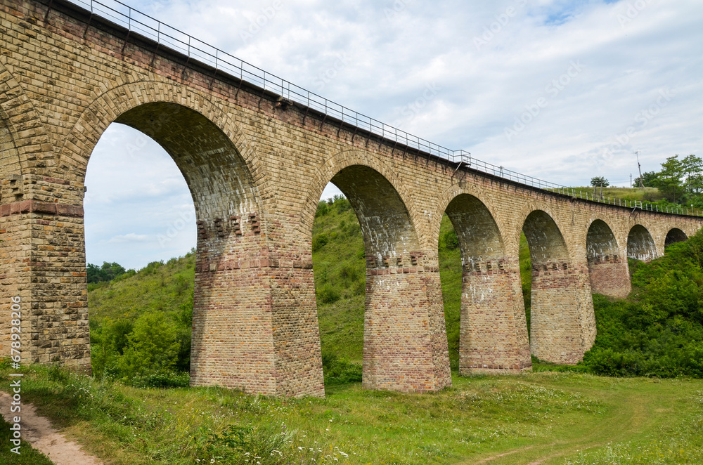 Ancient stone viaduct railway bridge built in the time of Austro-Hungarian Empire in Western Ukraine in Ternopil region in the village of Plebanivka Ancient stone viaduct railway bridge built in the time of Austro-Hungarian Empire in Western Ukraine in Ternopil region in the village of Plebanivka