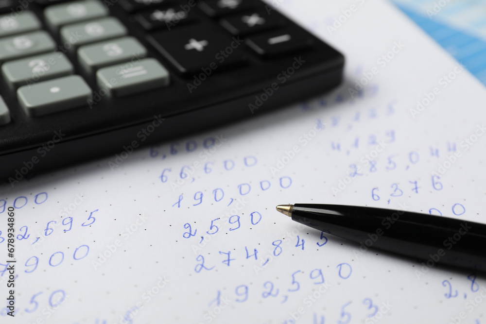Calculator and pen on document with data, closeup view Calculator and pen on document with data, closeup view