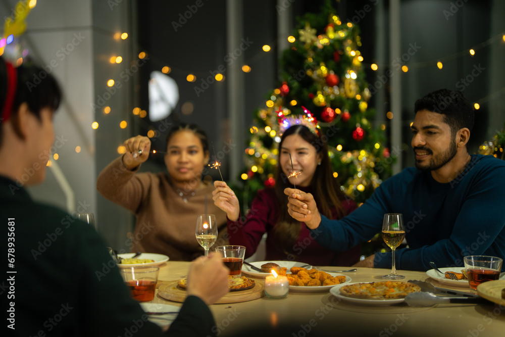 happy female and friends holding sparkler fireworks in a party with Christmas tree. young Asian people enjoy celebrating Christmas and New Year. celebrate with food wine and friendship for love, happy female and friends holding sparkler fireworks in a party with Christmas tree. young Asian people enjoy celebrating Christmas and New Year. celebrate with food wine and friendship for love,