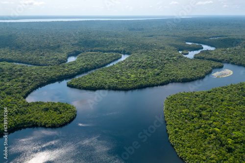 Aerial drone perspective of a bifurcated river meandering through untouched brazilian Amazon rainforest