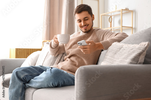 Young man with cup of tea a...