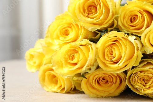 Beautiful bouquet of yellow roses on table, closeup