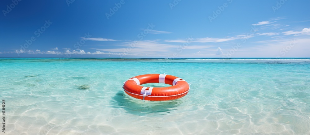 Lifebuoy in the turquoise water on a tropical beach