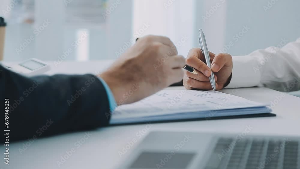 Hands of recruiter holding resume in front of candidate at desk. Hands of recruiter holding resume in front of candidate at desk.