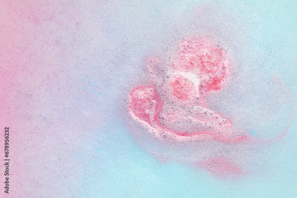 Colorful foam after dissolving bath bomb in water, closeup Colorful foam after dissolving bath bomb in water, closeup