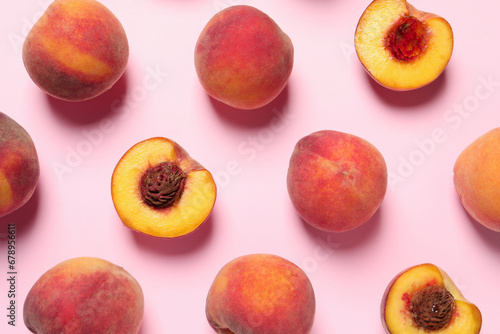 Cut and whole fresh ripe peaches on pink background, flat lay