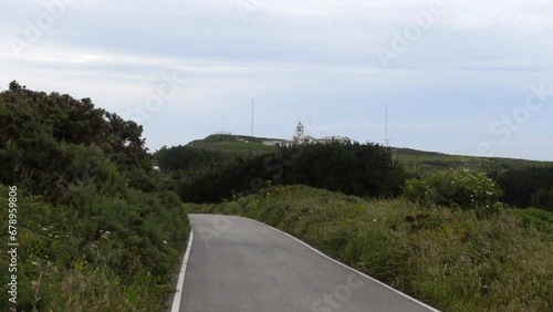 LIghthouse with zoom while walking by the main road in Village Estaca de Bares, Galicia on a Cloudy Day, with sony rx100 va 4K photo