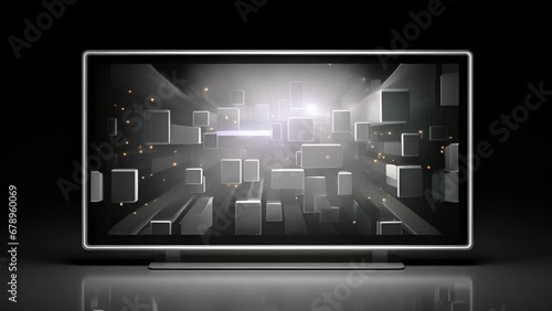 A silver rectangularshaped TV with bulky round s facing outwards. It has a simple design with a blackbacklit screen that shows an assembly of neon squares and arrows photo