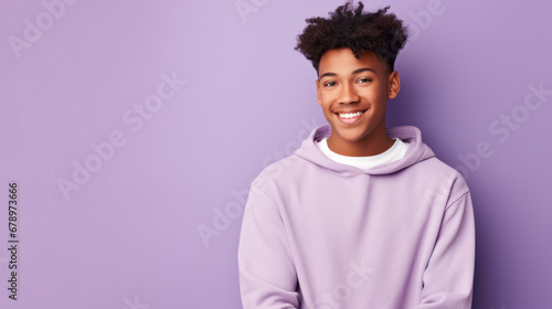 Happy, teen boy and portrait of a student smiling, high school and education concept with copy-space. Confident, African American male posing against a purple background in studio photo