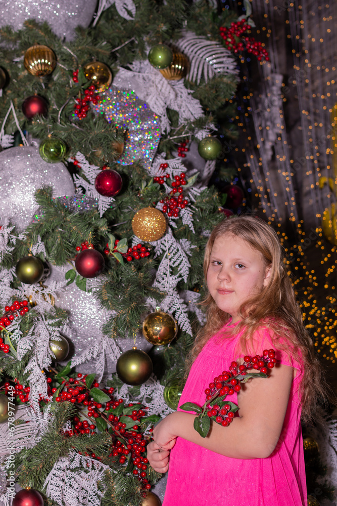 A beautiful elegant girl near the Christmas tree in the New Year A beautiful elegant girl near the Christmas tree in the New Year