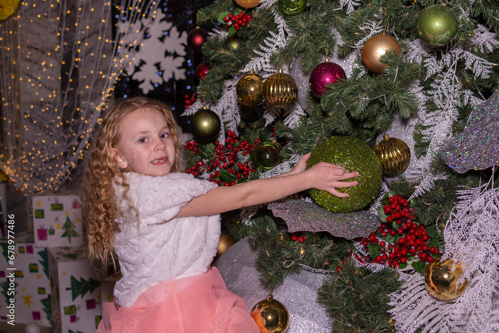 A beautiful elegant girl near the Christmas tree in the New Year A beautiful elegant girl near the Christmas tree in the New Year