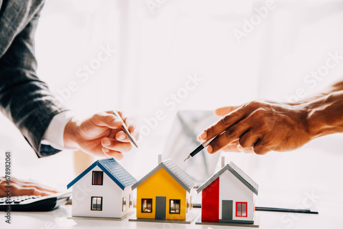 Real estate agent and customer signing contract to buy house, insurance or loan real estate.rent a house,get insurance or loan real estate or property.