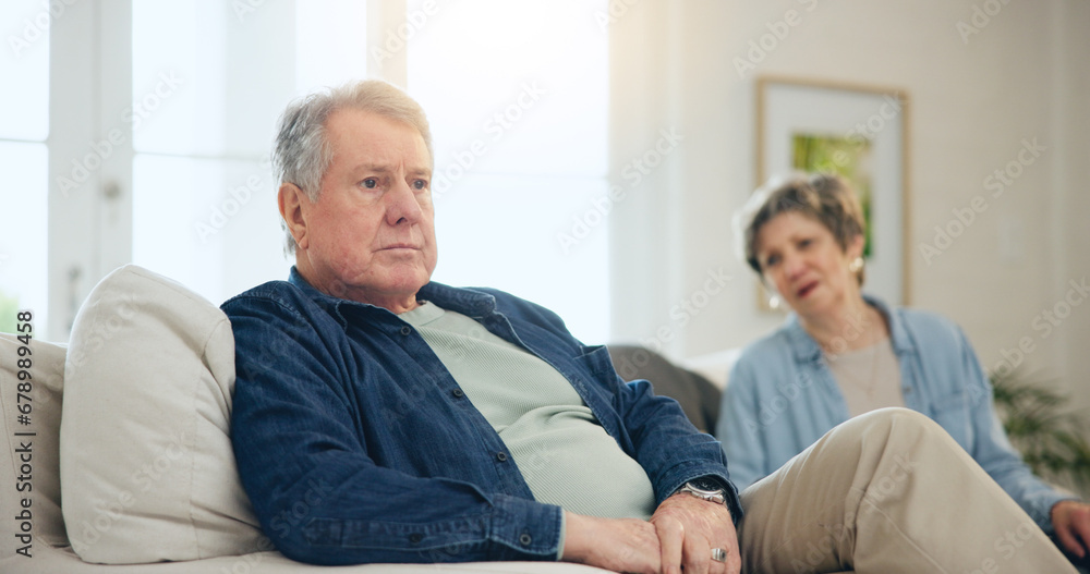 Obraz premium Senior, couple or stress with conflict and fight on sofa in living room of home with anger and silence. Elderly, man or woman with argument, upset and frustrated on couch in lounge of house or ignore