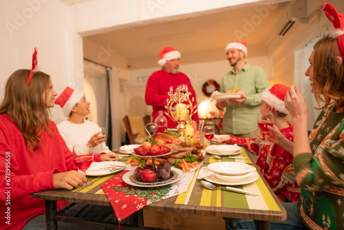 Group of happy family smiling happy celebrating christmas toasting with wine. Family member enjoy home made turkry grill dining togather at home. Christmas and New Year interior concept. photo