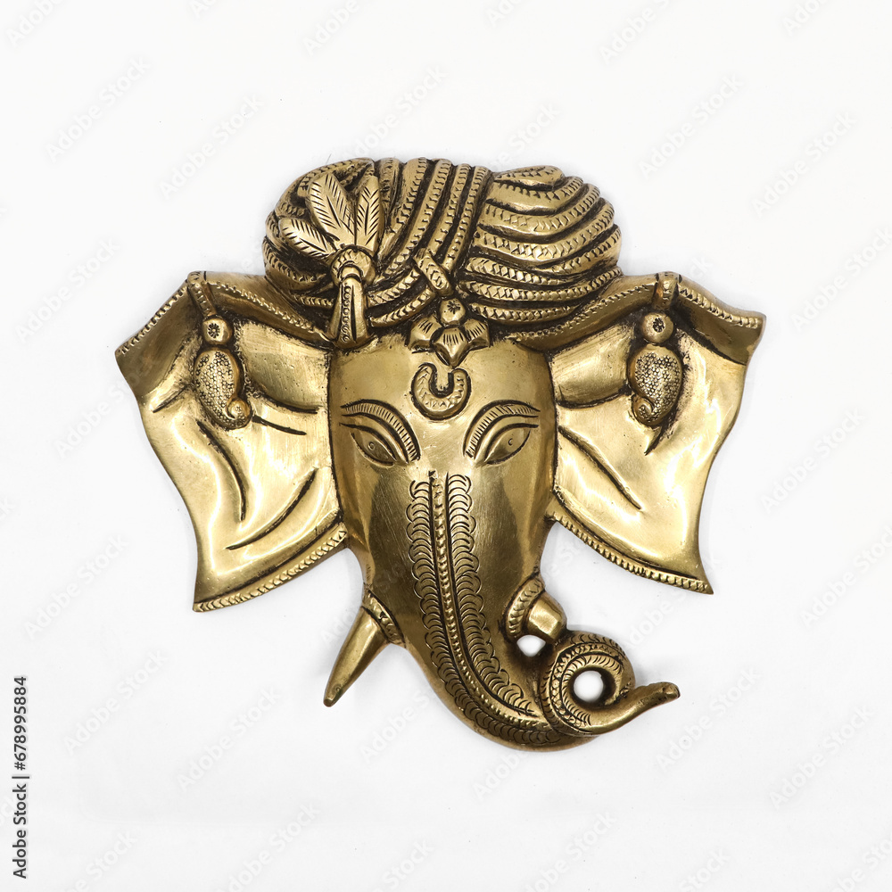 golden statue head of hindu elephant god ganesh with detailed hand carvings isolated in a white background golden statue head of hindu elephant god ganesh with detailed hand carvings isolated in a white background
