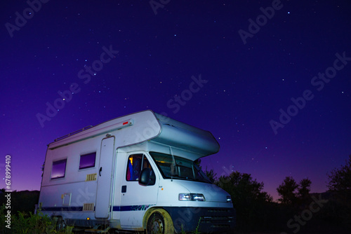 Night starry sky and camper rv.