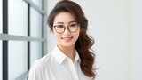 An Asian woman wearing glasses and a white shirt