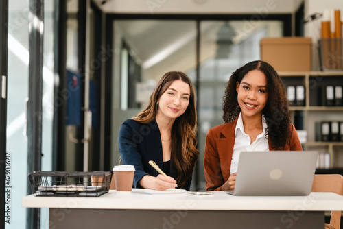 Two professional caucasian with african american businesswoman friends collaboration, working together at office, using laptop, Generally accepted audit standards, Earnings before interest and taxes