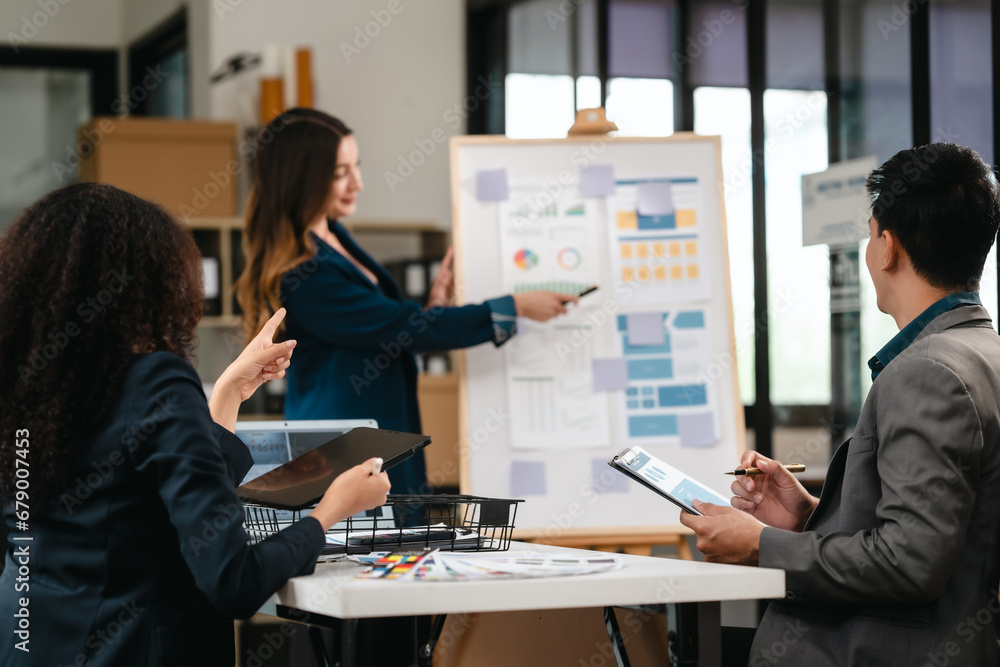 Fototapeta premium diverse team of professionals engaged in a website graphic design board meeting, sharing opinions on UX and UI design elements. Asian man, African American people, black, afro, caucasian female
