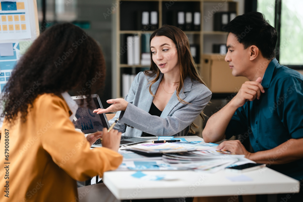 Obraz premium diverse team of professionals engaged in a website graphic design board meeting, sharing opinions on UX and UI design elements. Asian man, African American people, black, afro, caucasian female