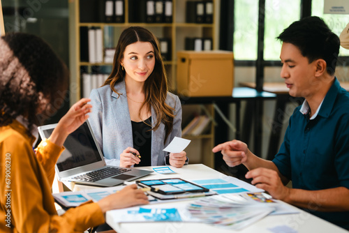 diverse team of professionals engaged in a website graphic design board meeting, sharing opinions on UX and UI design elements. Asian man, African American people, black, afro, caucasian female