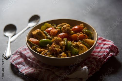 Indian main course dish mixed veg curry prepared with carrots, cauliflower, beans, capsicum and paneer or cottage cheese served in a bowl. Close up, selective focus. photo