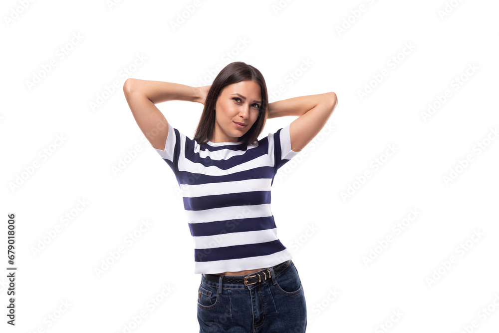 slender confident young caucasian brunette woman dressed in summer clothes in a striped t-shirt holds black and white slender confident young caucasian brunette woman dressed in summer clothes in a striped t-shirt holds black and white