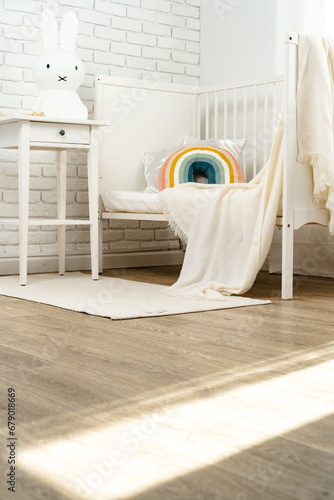 Fototapeta Naklejka Na Ścianę i Meble -  Kid's room interior with comfortable bed and rainbow pillow