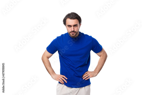 portrait of a young smart caucasian brunette man with a beard in a blue t-shirt © Ivan Traimak