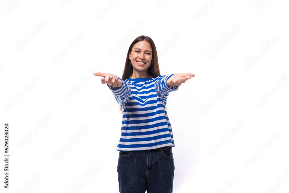 young confident european brunette woman dressed in striped blue clothes on a white studio background young confident european brunette woman dressed in striped blue clothes on a white studio background