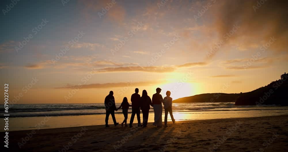 Family, walk and holding hands with silhouette, beach and sunset with freedom, vacation and outdoor together, Men, women and children by ocean, sand and waves with back, love and support in Mexico Family, walk and holding hands with silhouette, beach and sunset with freedom, vacation and outdoor together, Men, women and children by ocean, sand and waves with back, love and support in Mexico