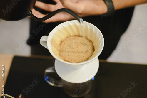 coffee drip, Barista making drip coffee by pouring spills hot water on coffee ground with prepare filter 