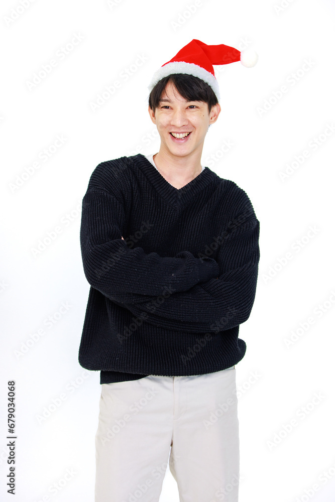 Isolated cutout studio shot Asian cheerful male model wears red Santa Claus hat standing smiling posing celebrated Christmas eve on white background. Isolated cutout studio shot Asian cheerful male model wears red Santa Claus hat standing smiling posing celebrated Christmas eve on white background.