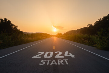 Happy new year 2024,2024 symbolizes the start of the new year. The letter start new year 2024 on the road in the nature route roadway sunset tree environment ecology or greenery wallpaper concept.
