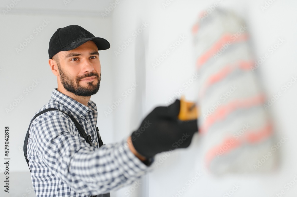 Young worker making repair in room. Young worker making repair in room.