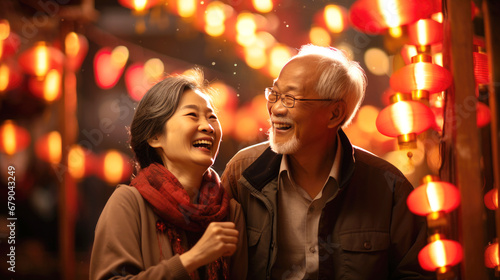smiling Chinese old couple on lanterns background, lunar spring festival