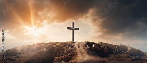 Holy cross symbolizing the death and resurrection of Jesus Christ with the sky over Golgotha Hill is shrouded in light and clouds. Apocalypse concept © LELISAT