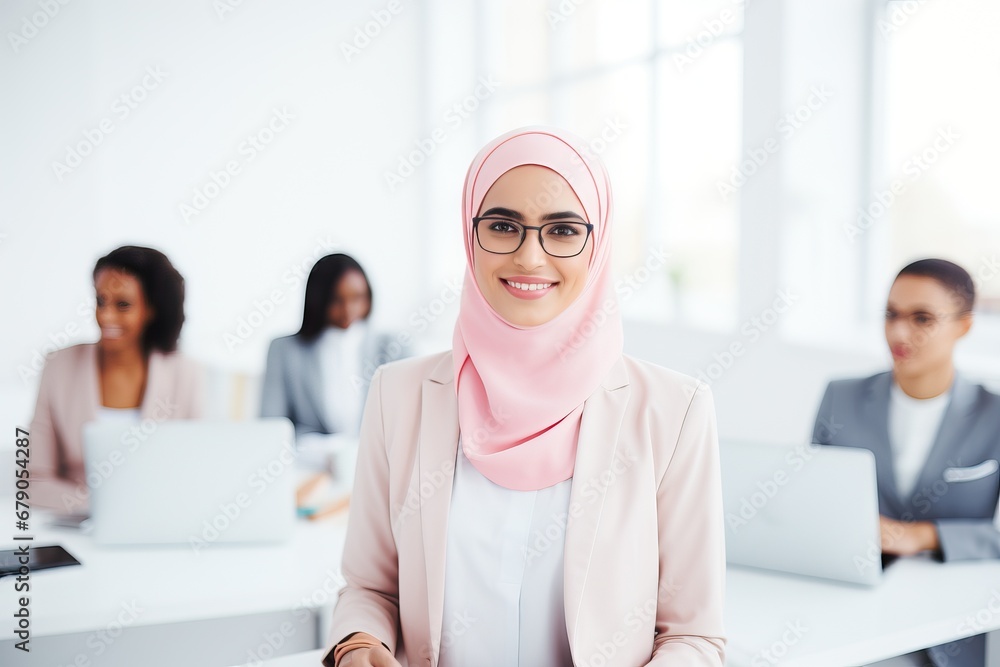 Confident woman in hijab with a professional team in the background Confident woman in hijab with a professional team in the background