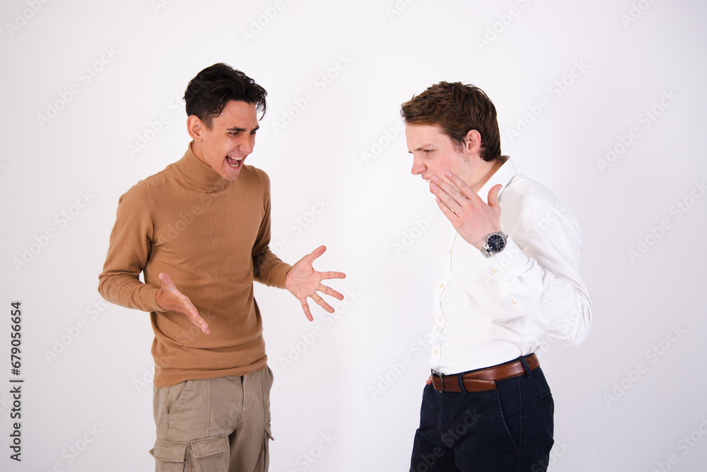 Two young attractive friends are arguing. Gay couple posing in the studio. Two young attractive friends are arguing. Gay couple posing in the studio.