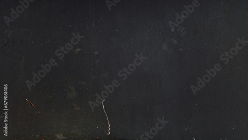 Black wall background with scratches and dust. Black wall grunge texture. Abstract background for design.