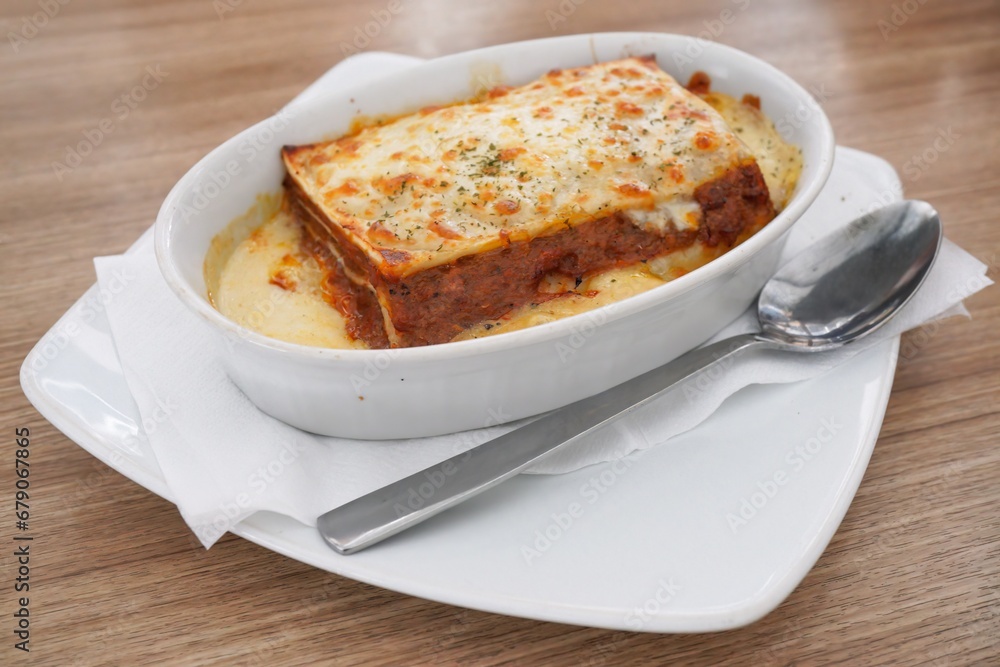 Lasagna. Homemade Italian lasagna with meat, sauce, cheese and basil on a wooden background, Lasagna. Homemade Italian lasagna with meat, sauce, cheese and basil on a wooden background,