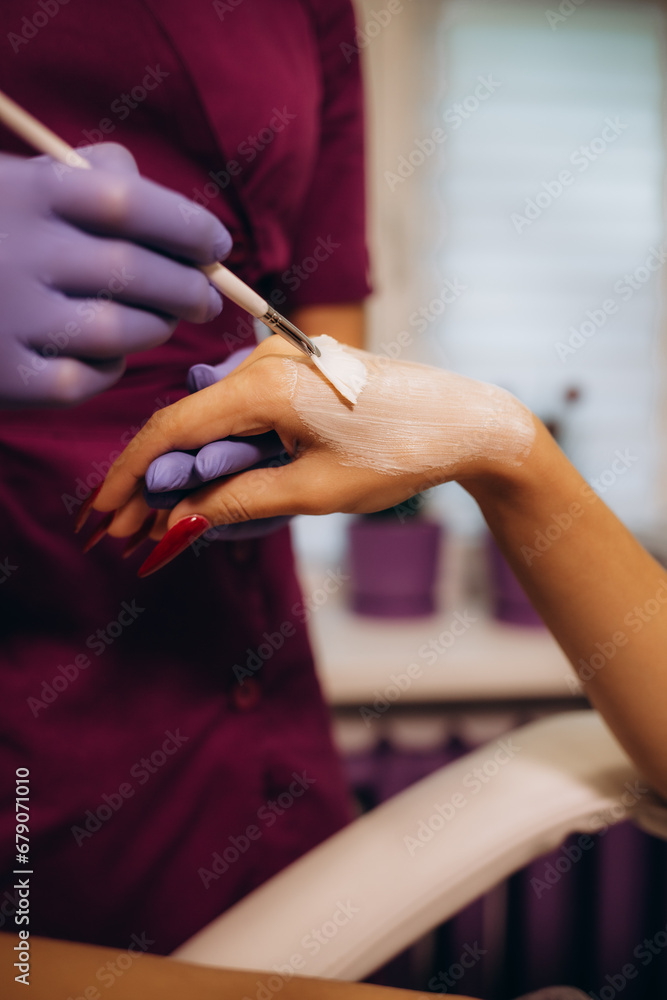 Obraz premium spa and treatment skin hand, Woman applying organic moisturizing hand cream, hand skin care concept, winter, female skin protection, beautiful woman skin care with hand cream, lotion on hands