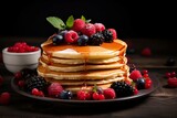Stack of pancakes with syrup and berries