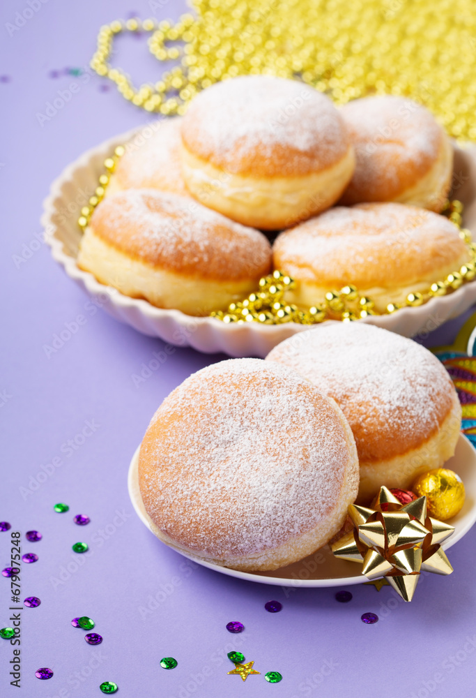 Mardi Gras King Cake Doughnuts or Donuts, Carnival Masks on Purple Background.